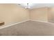 Spacious living room featuring neutral walls, carpet and a modern light fixture at 3176 Feltrim Pl # 205, Kissimmee, FL 34747