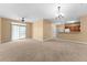 Large living room with sliding glass doors, ceiling fan, and view of kitchen, creating an open and airy atmosphere at 3176 Feltrim Pl # 205, Kissimmee, FL 34747