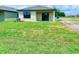 Backyard featuring a patio, grass, and a view of the adjacent lot at 3225 Cup Dr, Lakeland, FL 33803