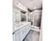 Modern bathroom featuring double sinks, white cabinets, and a stylish glass-enclosed shower at 3225 Cup Dr, Lakeland, FL 33803