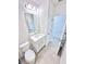 A bathroom features a white sink, toilet, and a large mirror, all in a modern design at 3225 Cup Dr, Lakeland, FL 33803