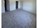 Spacious bedroom featuring neutral paint, grey carpet, and natural light at 3225 Cup Dr, Lakeland, FL 33803