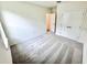 A carpeted bedroom featuring a walk-in closet and a door to the hallway at 3225 Cup Dr, Lakeland, FL 33803