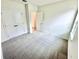 A light-filled bedroom featuring neutral carpet and double closet doors at 3225 Cup Dr, Lakeland, FL 33803