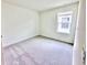 Bright bedroom featuring carpet floors and a single window at 3225 Cup Dr, Lakeland, FL 33803