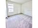 Bright bedroom with neutral carpet, a window, and fresh white paint at 3225 Cup Dr, Lakeland, FL 33803