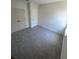 Bedroom featuring neutral paint, grey carpet and walk-in closet at 3225 Cup Dr, Lakeland, FL 33803