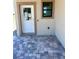 Home entryway with a modern door and a stylish, grey, tiled patio at 3225 Cup Dr, Lakeland, FL 33803