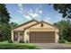 Charming single-story home with neutral siding, a two-car garage, and stone accents at 3225 Cup Dr, Lakeland, FL 33803