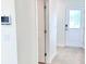 Bright hallway with a white door to the backyard and a light-colored tile floor at 3225 Cup Dr, Lakeland, FL 33803