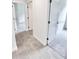 Tiled hallway view that leads to a bedroom and bathroom, providing easy access throughout the house at 3225 Cup Dr, Lakeland, FL 33803