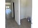 Hallway featuring neutral paint, tile flooring, and an open floor plan at 3225 Cup Dr, Lakeland, FL 33803