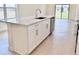 A large kitchen island with white cabinetry and quartz countertop at 3225 Cup Dr, Lakeland, FL 33803