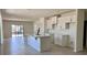 Open kitchen with white cabinetry, large island, stainless steel faucet, and lots of light at 3225 Cup Dr, Lakeland, FL 33803