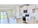 Modern kitchen with white cabinets, stainless steel appliances, and a kitchen island at 3225 Cup Dr, Lakeland, FL 33803