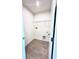 Laundry room with tile flooring, wire shelving, and hookups for a washer and dryer at 3225 Cup Dr, Lakeland, FL 33803