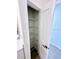 Bright linen closet featuring metal shelves and tile floors at 3225 Cup Dr, Lakeland, FL 33803