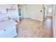Open-concept living space with tile flooring, leading to a kitchen and hallway at 3225 Cup Dr, Lakeland, FL 33803