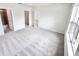 Carpeted primary bedroom with large window, walk-in closet, and ensuite bathroom at 3225 Cup Dr, Lakeland, FL 33803