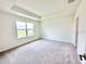 Bright main bedroom features a trey ceiling, plush carpet flooring, and natural light at 3225 Cup Dr, Lakeland, FL 33803