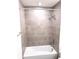 Modern shower showcasing tiled walls with a showerhead and fixtures at 3225 Cup Dr, Lakeland, FL 33803