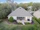 Aerial view of the home's backyard featuring a screened patio, outdoor seating, and lush landscaping at 325 Bellingrath Terrace, Deland, FL 32724