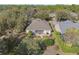 Aerial view showcases the property's backyard with an outdoor patio and well-maintained landscaping at 325 Bellingrath Terrace, Deland, FL 32724
