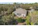 Aerial view features the home's landscaped backyard, patio, and outdoor living space in a serene setting at 325 Bellingrath Terrace, Deland, FL 32724
