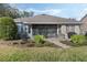 Beautiful backyard featuring a screened patio, a grilling area and manicured landscaping for outdoor enjoyment at 325 Bellingrath Terrace, Deland, FL 32724