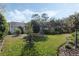 Lush backyard with a well-maintained lawn and mature trees, offering privacy and a peaceful setting at 325 Bellingrath Terrace, Deland, FL 32724