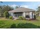 Landscaped backyard with a screened patio area ideal for outdoor dining and leisure at 325 Bellingrath Terrace, Deland, FL 32724