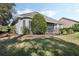 Well-kept backyard with lush landscaping and a screened patio, perfect for relaxation at 325 Bellingrath Terrace, Deland, FL 32724