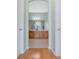 Bathroom with dual sinks, wood cabinets, tile floors and tub with a shower at 325 Bellingrath Terrace, Deland, FL 32724