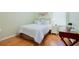 Cozy bedroom featuring wood floors, soothing color palette and natural light at 325 Bellingrath Terrace, Deland, FL 32724