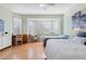 Bedroom with hardwood floors, a ceiling fan, and a bay window at 325 Bellingrath Terrace, Deland, FL 32724