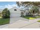 Charming single-Gathering home featuring a well-manicured lawn and a classic two-car garage at 325 Bellingrath Terrace, Deland, FL 32724