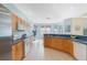 Kitchen features tiled floors, stainless steel appliances, wood cabinets, eat-in nook, and stone countertops at 325 Bellingrath Terrace, Deland, FL 32724