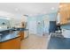Open-concept kitchen with tiled floors, stainless steel appliances and stone countertops at 325 Bellingrath Terrace, Deland, FL 32724