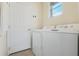 Clean laundry room with a washer and dryer next to a door at 325 Bellingrath Terrace, Deland, FL 32724