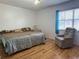 Bedroom with hardwood flooring, a bed, and a comfortable chair at 370 N Windmeadows St # 370, Altamonte Springs, FL 32701