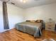 Neutral bedroom featuring hardwood floors, ceiling fan and side table with lamp at 370 N Windmeadows St # 370, Altamonte Springs, FL 32701