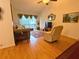 Inviting living room featuring hardwood floors, a large window, and a seating area at 370 N Windmeadows St # 370, Altamonte Springs, FL 32701