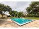Community pool with blue water, surrounded by mature trees and greenery at 370 N Windmeadows St # 370, Altamonte Springs, FL 32701