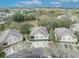 Real estate aerial highlighting well-kept homes nestled amongst mature trees and landscaping at 466 Ashley Brooke Ct # C, Apopka, FL 32712