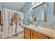 Cozy bathroom features a shower with patterned curtain, neutral walls, and wood vanity at 466 Ashley Brooke Ct # C, Apopka, FL 32712