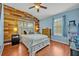 Charming bedroom with wood-paneled accent wall, light blue walls, and wood-look flooring at 466 Ashley Brooke Ct # C, Apopka, FL 32712