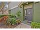 Charming front entrance with lush landscaping and a welcoming dark colored door at 466 Ashley Brooke Ct # C, Apopka, FL 32712