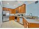 Well-lit kitchen with stainless steel appliances, tile backsplash, and wooden cabinets at 466 Ashley Brooke Ct # C, Apopka, FL 32712