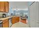 Open kitchen with stainless appliances, tiled floor, and a view to the living room at 466 Ashley Brooke Ct # C, Apopka, FL 32712