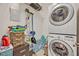 Functional laundry area featuring a stacked washer and dryer, storage, and organization at 466 Ashley Brooke Ct # C, Apopka, FL 32712